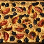 Tepside pişirilmiş domates ve zeytinli ev yapımı İtalyan focaccia ekmeği
