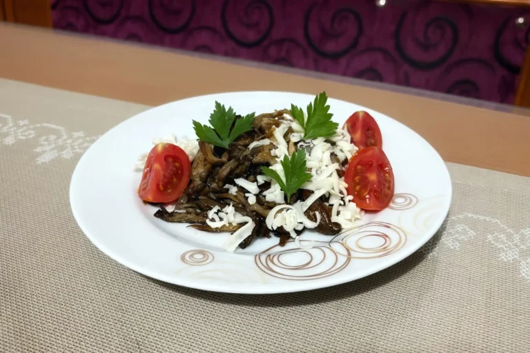 Golden brown sautéed oyster mushrooms in a plate with cheeese and cherry tomatoes